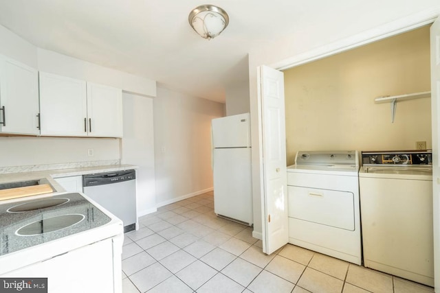 clothes washing area featuring washer and clothes dryer and light tile patterned flooring