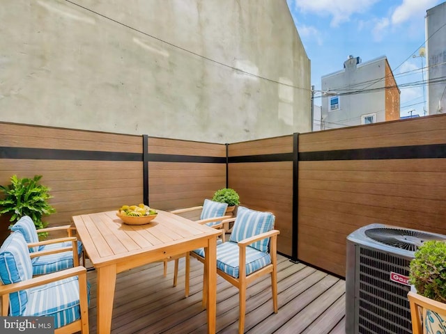 wooden balcony with central AC and a wooden deck