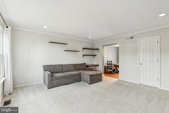 living room featuring ornamental molding and light carpet