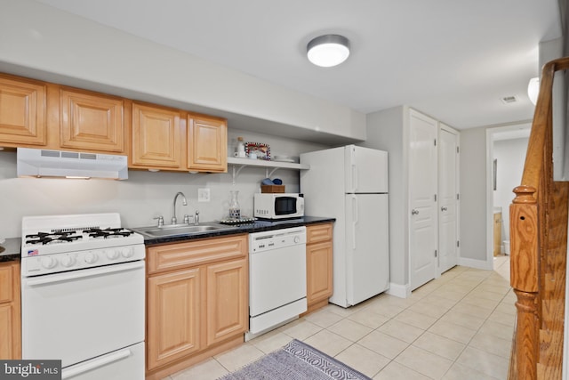 kitchen with light tile patterned floors, white appliances, light brown cabinets, and sink