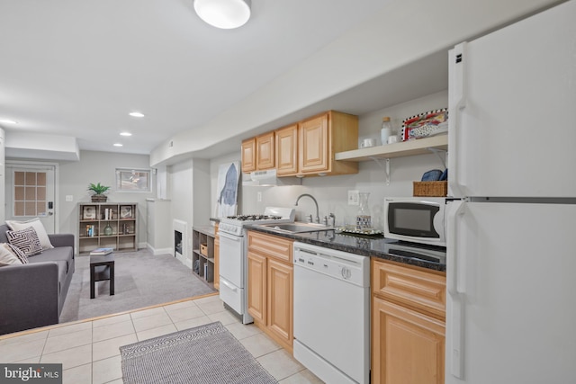 kitchen featuring light colored carpet, white appliances, sink, and light brown cabinetry