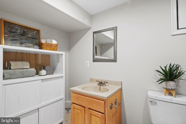 bathroom with tile patterned floors, vanity, and toilet