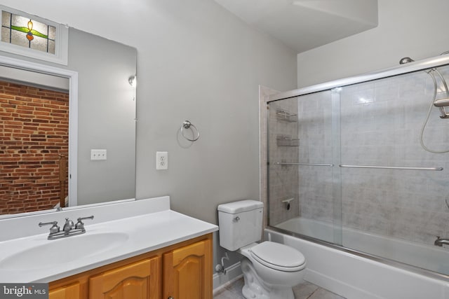 full bathroom with tile patterned flooring, vanity, toilet, and bath / shower combo with glass door