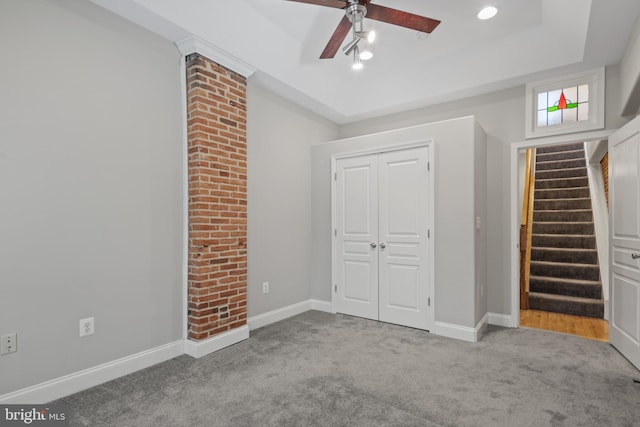 unfurnished bedroom featuring light carpet, a closet, and ceiling fan