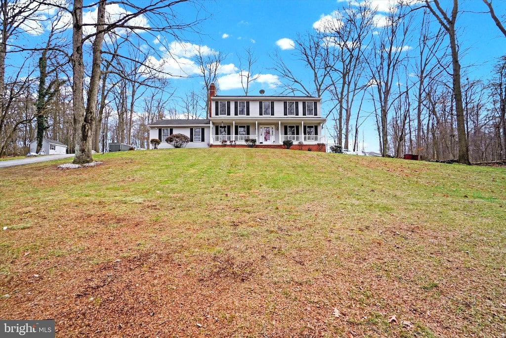 view of front of home featuring a front yard and a porch