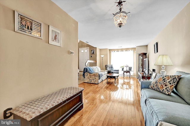 living room featuring light hardwood / wood-style flooring and a notable chandelier