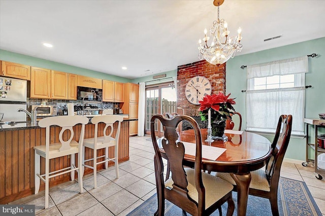 dining area with a notable chandelier and light tile patterned floors