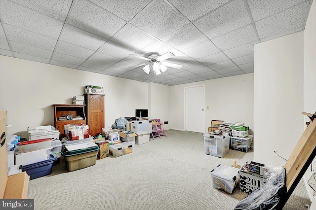 interior space featuring carpet, a paneled ceiling, and ceiling fan