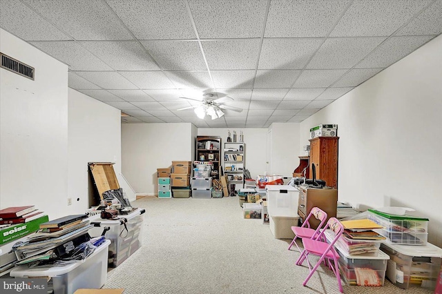 rec room with a paneled ceiling, ceiling fan, and carpet floors