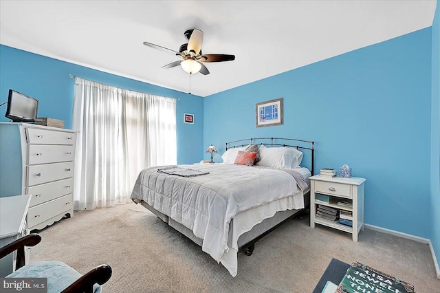 bedroom with ceiling fan and light carpet