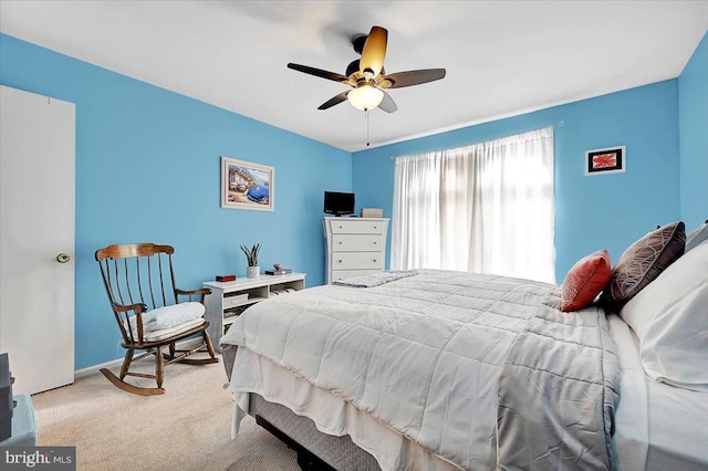 bedroom with ceiling fan and light carpet