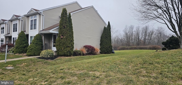 view of side of home featuring a lawn