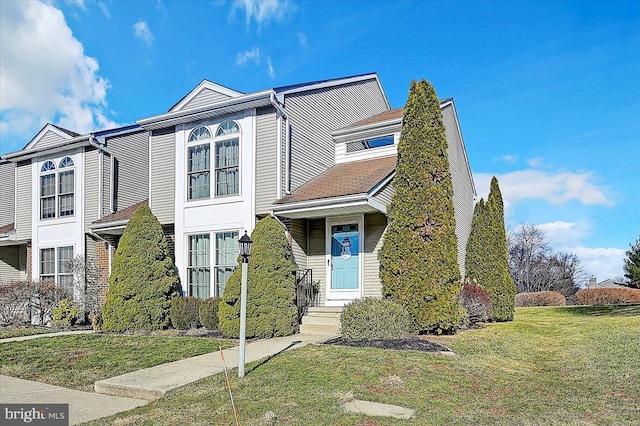 view of property featuring a front lawn