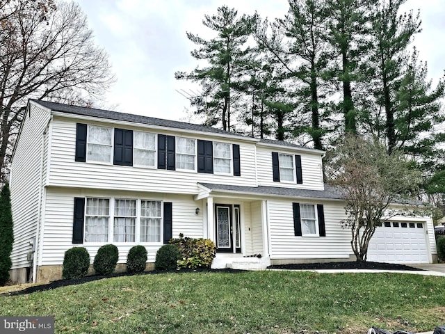 view of front of house with a front yard and a garage