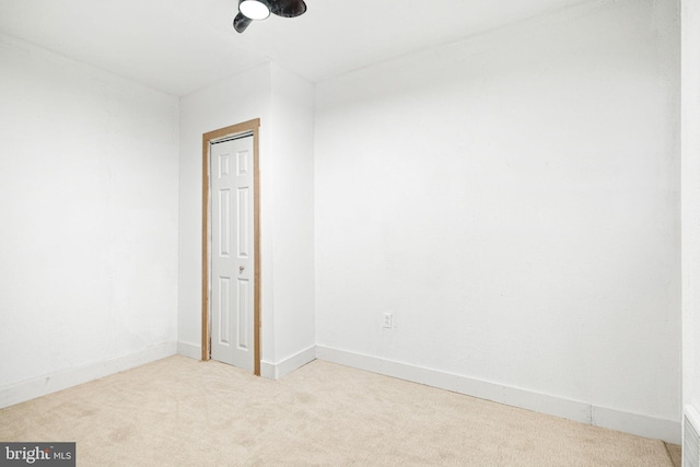 unfurnished room with light colored carpet