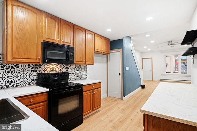 kitchen featuring ceiling fan, sink, tasteful backsplash, light hardwood / wood-style flooring, and black appliances