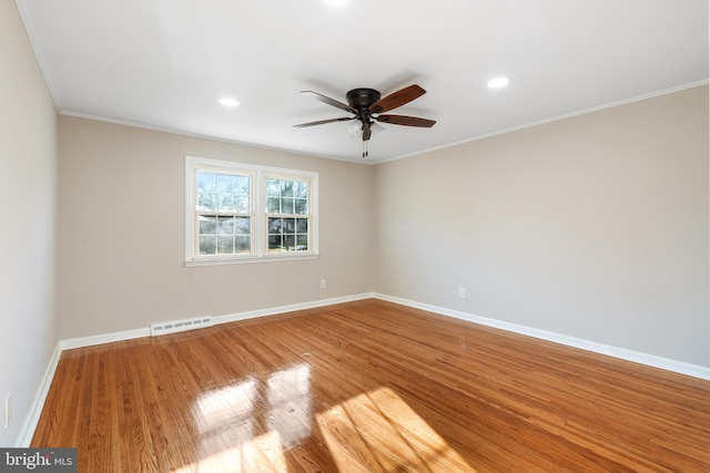 unfurnished room featuring hardwood / wood-style flooring, ceiling fan, and crown molding