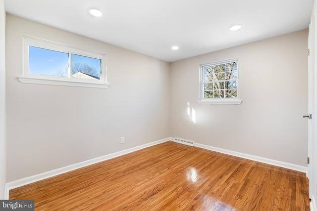 spare room with hardwood / wood-style flooring