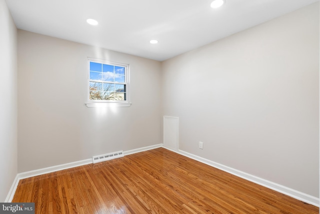 spare room featuring hardwood / wood-style flooring