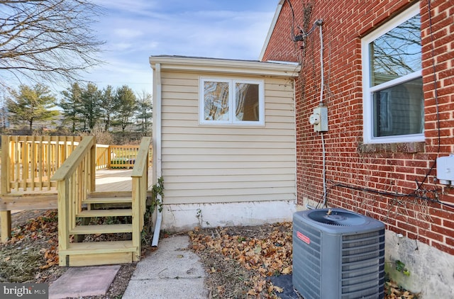 view of side of home featuring a deck and central air condition unit