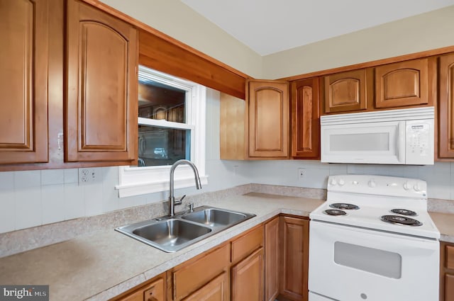 kitchen with backsplash, sink, and white appliances