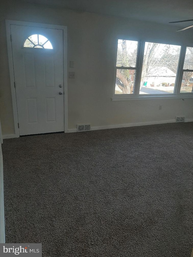 entrance foyer with carpet flooring and ceiling fan