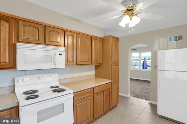 kitchen featuring light tile patterned floors, white appliances, and ceiling fan