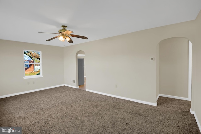 unfurnished room featuring dark carpet and ceiling fan