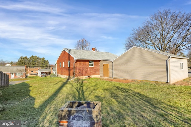 rear view of house featuring a lawn