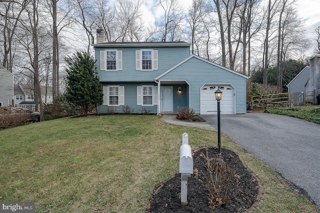 view of front property with a garage and a front yard