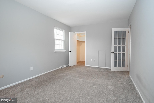 unfurnished room with light carpet