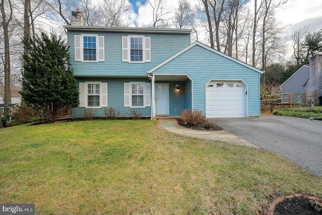 view of front of home with a front yard and a garage