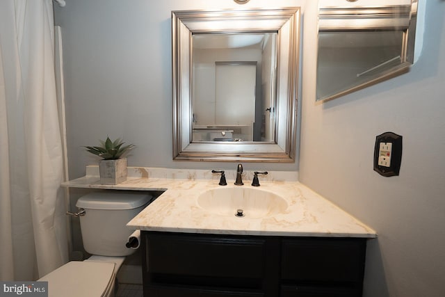 bathroom featuring vanity and toilet