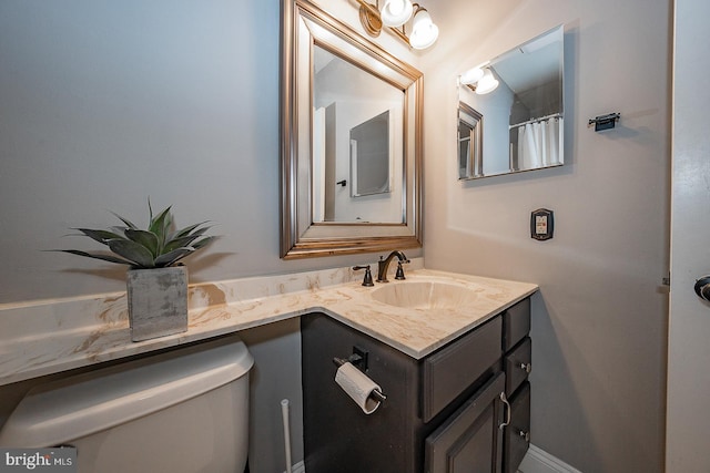 bathroom featuring vanity and toilet