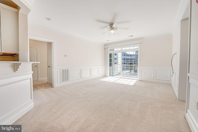 carpeted empty room featuring ceiling fan and ornamental molding