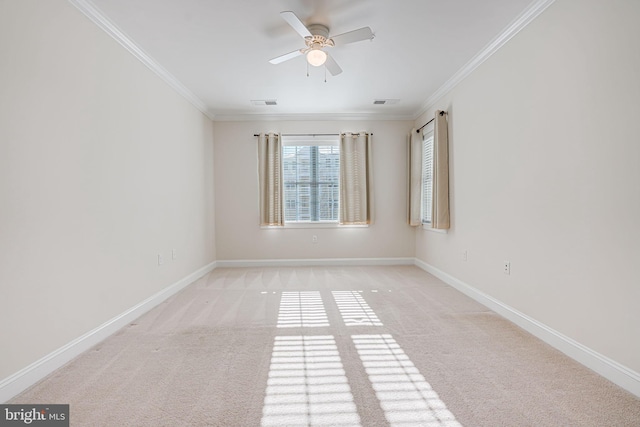 carpeted spare room with crown molding and ceiling fan