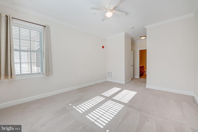 empty room with ceiling fan, ornamental molding, and light carpet