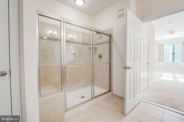 bathroom featuring tile patterned floors, ceiling fan, and an enclosed shower