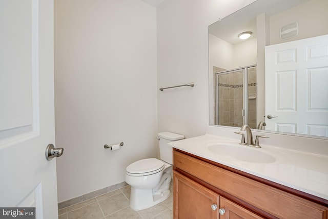 bathroom with toilet, tile patterned flooring, walk in shower, and vanity