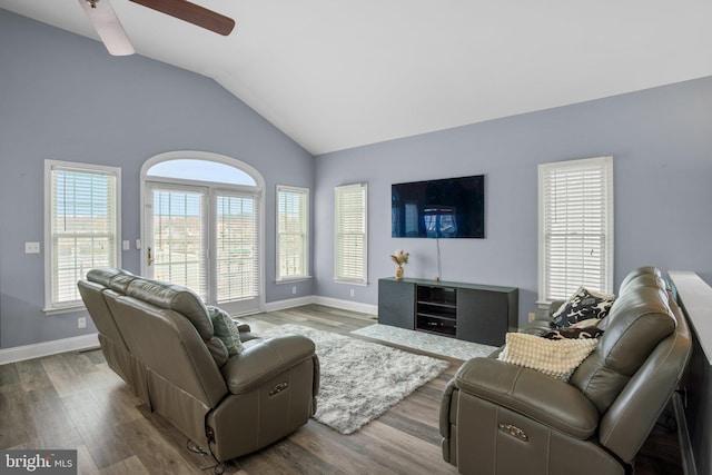 living room featuring lofted ceiling, ceiling fan, and wood-type flooring