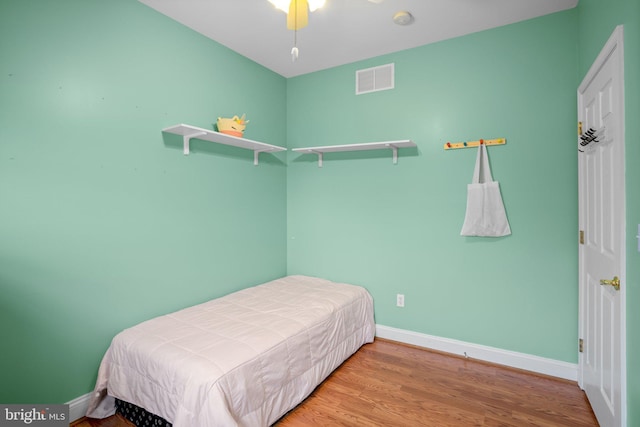 bedroom featuring hardwood / wood-style flooring and ceiling fan