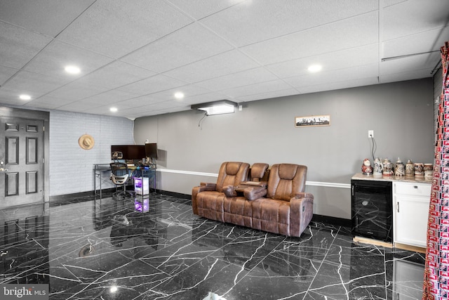 living room with bar, a paneled ceiling, and beverage cooler