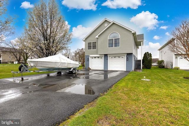 view of side of home with a lawn and a garage