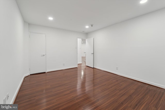 unfurnished room featuring dark hardwood / wood-style flooring