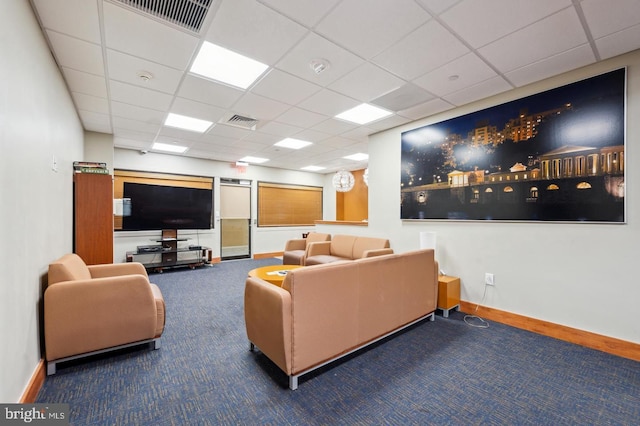 living room featuring a paneled ceiling and carpet