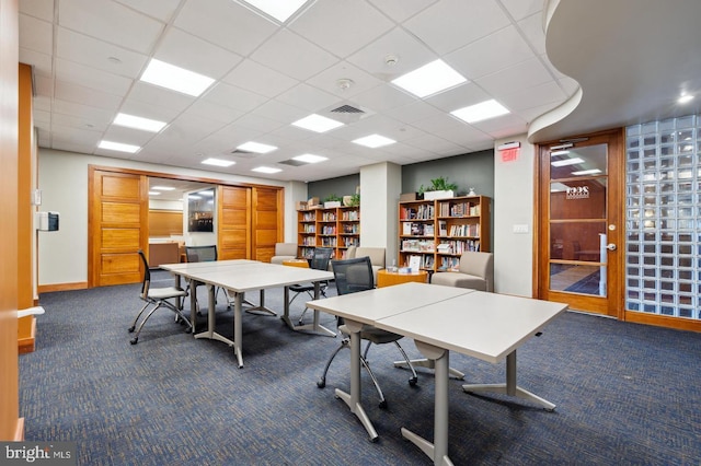 carpeted office featuring a drop ceiling