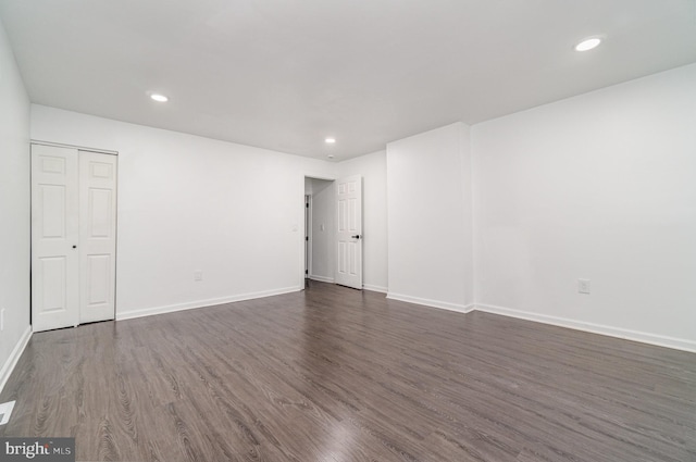 spare room featuring dark wood-type flooring