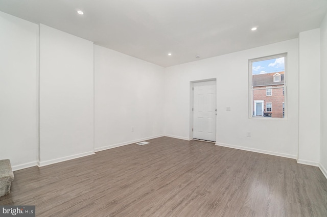 unfurnished room with dark hardwood / wood-style floors