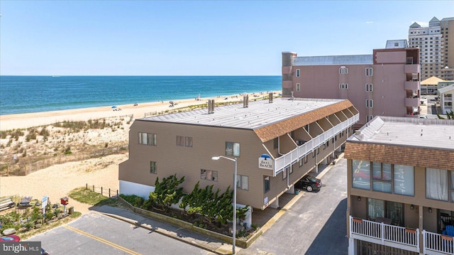 drone / aerial view featuring a view of the beach and a water view