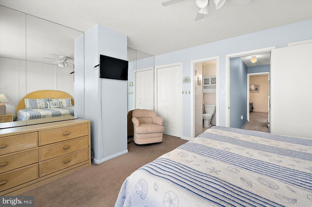 bedroom featuring dark colored carpet, ceiling fan, and ensuite bath